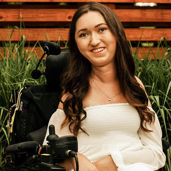 IMG_4502 portrait of tori hunter, brunette, smiling in her power wheelchair